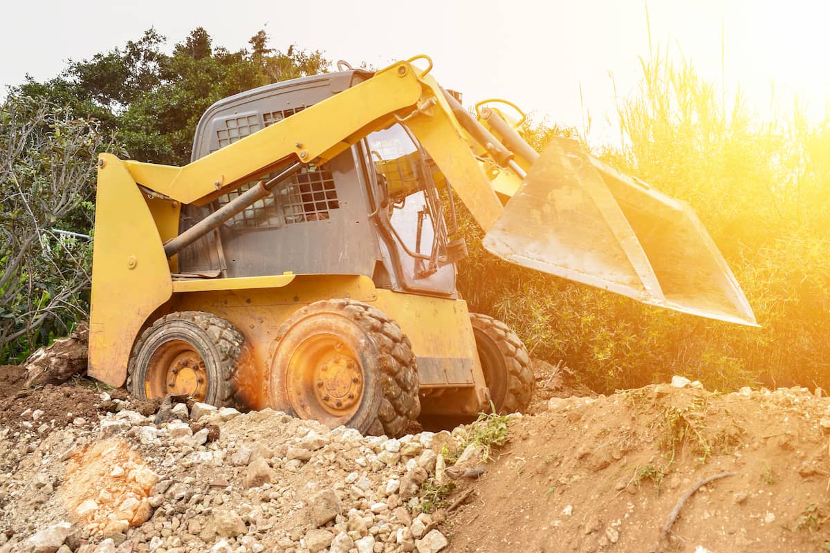 Skid Steer in its natural habitat happily moving dirt.
